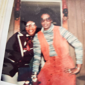 Two women posing for an old snapshot.