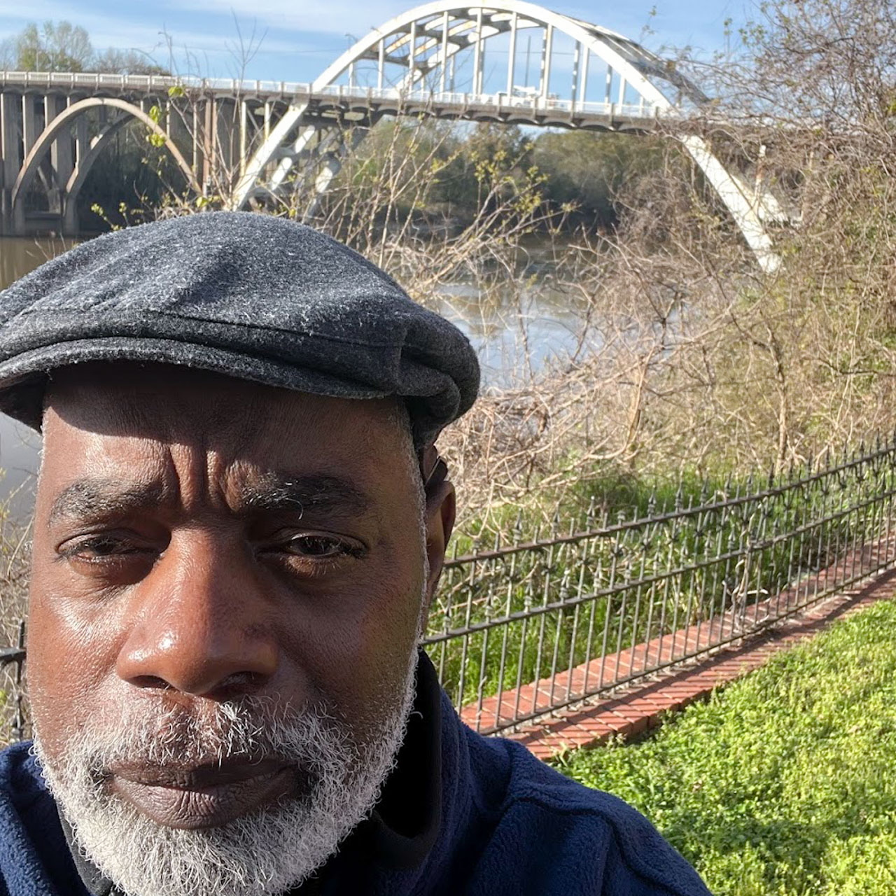 Charles Thomas in front of a bridge
